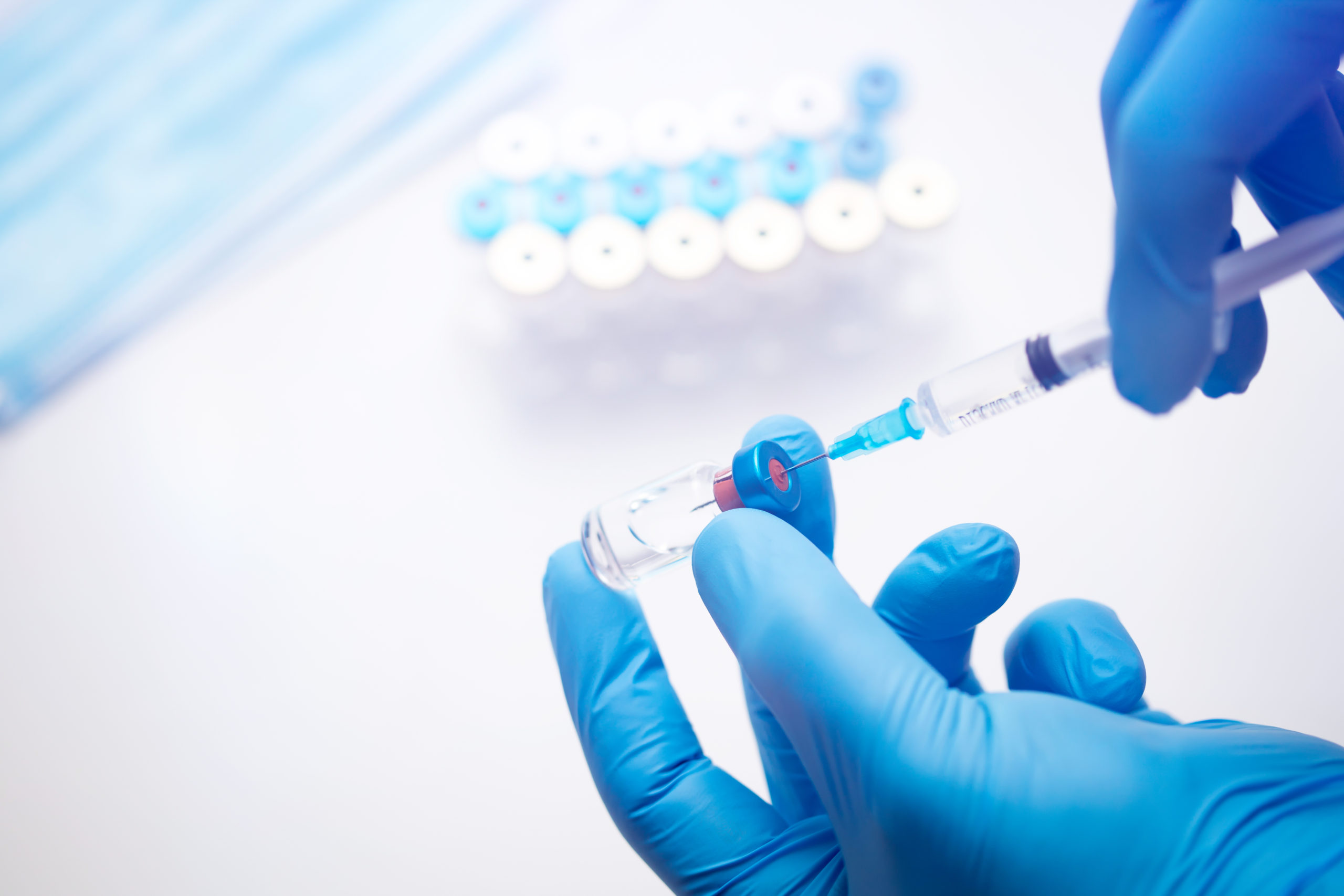 Close up on vaccine and medical syringe