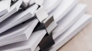 panoramic-shot-of-stacks-of-blank-paper-with-metal-2021-09-03-01-46-49-utc